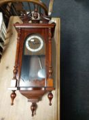 A beech cased Bentima wall clock with silvered dial