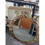 An ornate gilt circular mirror and a quantity of pictures and prints,