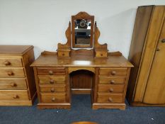 A contemporary pine mirror back dressing table fitted eight drawers