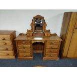 A contemporary pine mirror back dressing table fitted eight drawers