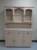 A painted kitchen dresser fitted cupboards and drawers beneath