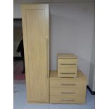 A contemporary oak effect single door wardrobe together with matching three drawer chest and two