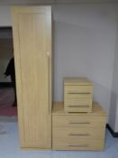 A contemporary oak effect single door wardrobe together with matching three drawer chest and two