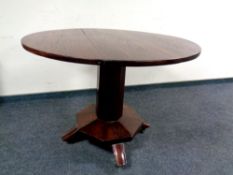 A Victorian circular tilt top table on octagonal pedestal