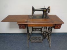 A 20th century Singer treadle sewing machine in mahogany table