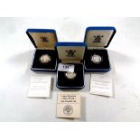 Three Royal Mint silver proof one pound coins, 1983, 1997 and 1998,