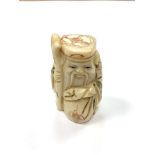 A Chinese bone netsuke - A Bearded Man with Sack.