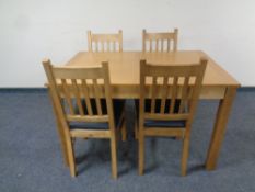 A contemporary extending dining table fitted a leaf together with a set of four ladder back chairs