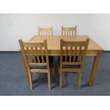 A contemporary extending dining table fitted a leaf together with a set of four ladder back chairs