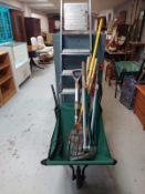 A folding barrow containing garden tools together with an aluminium stepladder