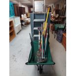 A folding barrow containing garden tools together with an aluminium stepladder