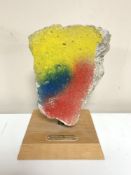 A piece of concrete from the Berlin Wall mounted on wooden plinth with plaque,