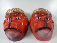 A pair of Chinese papier mache festival masks