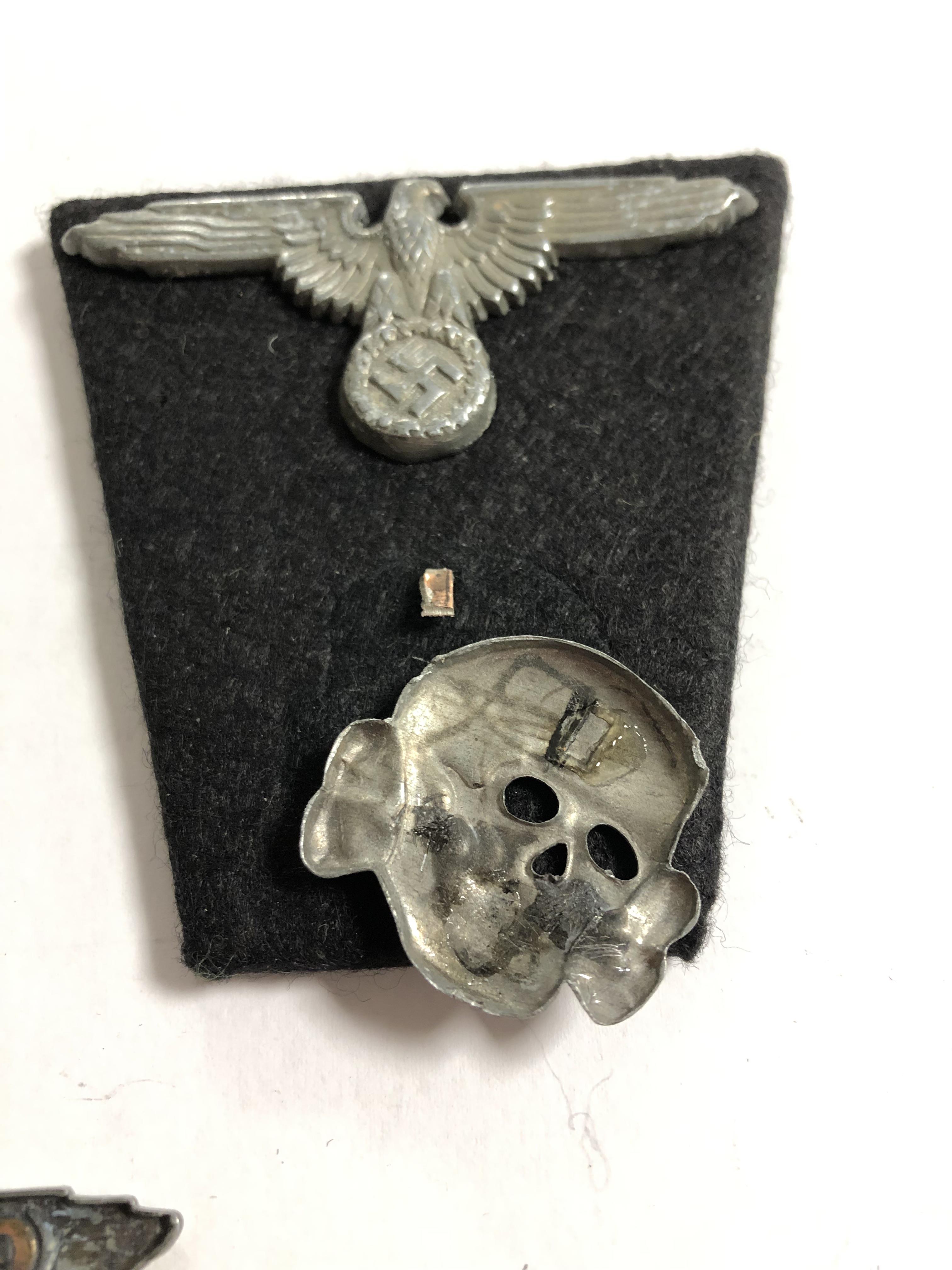 A group of German insignia including two Totenkopf skull cap badges, two eagle cap badges, - Image 7 of 8