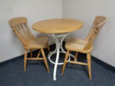 A circular bistro style table on bentwood base together with two stripped pine dining chairs