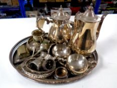 A silver plated gallery tray containing four piece tea service, plated napkin rings, cutlery,