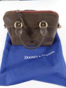 A lady's Dooney and Bourke Italian leather handbag with protective carrying bag