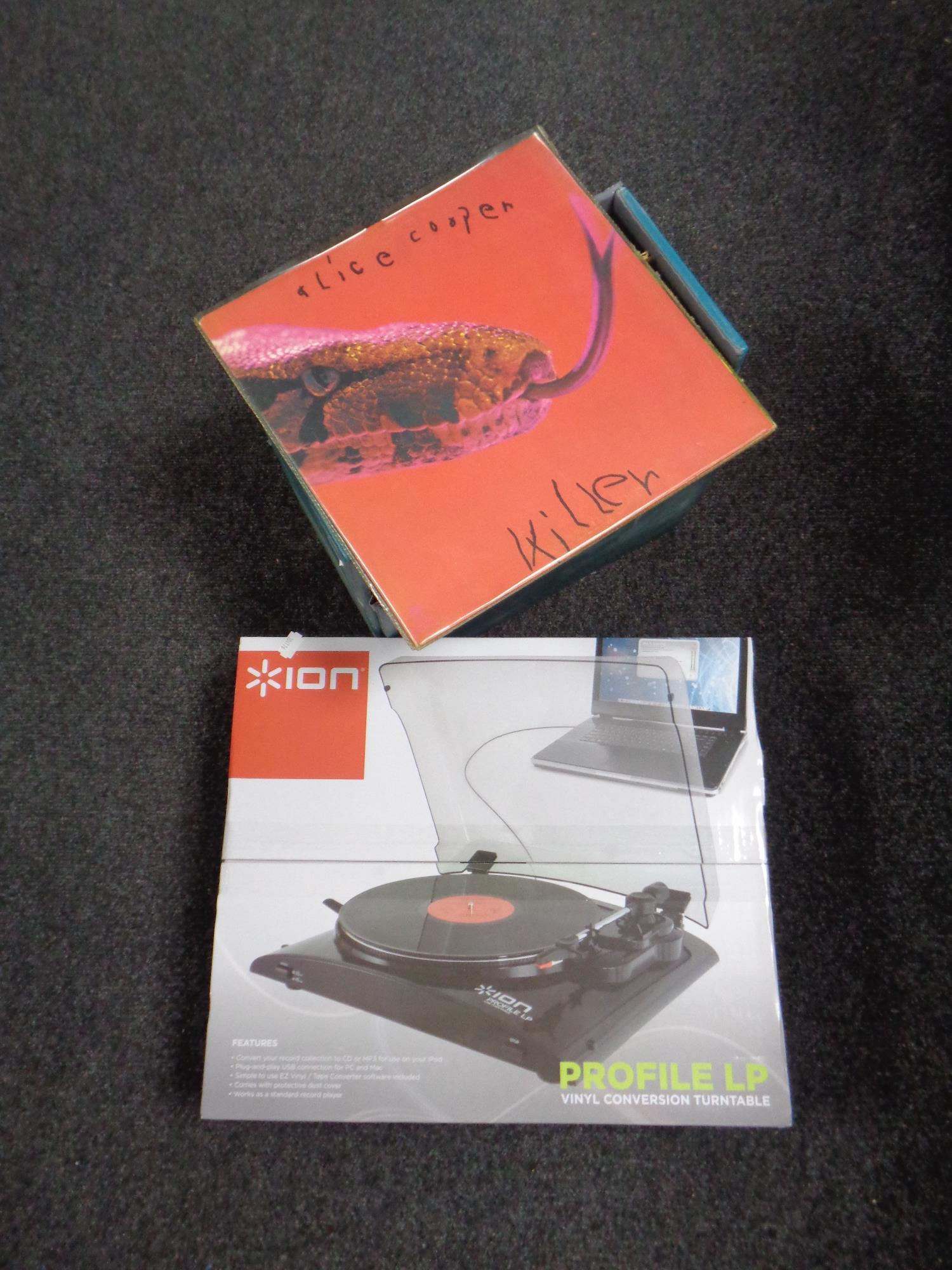 A boxed Ion Profile LP turntable together with a case containing vinyl LPs to include Alice Cooper,