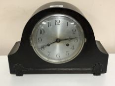 An early twentieth century oak cased mantle clock with pendulum