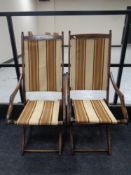 A pair of 20th century beech folding campaign style chairs upholstered in a striped fabric