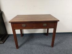 An Edwardian oak table fitted two drawers