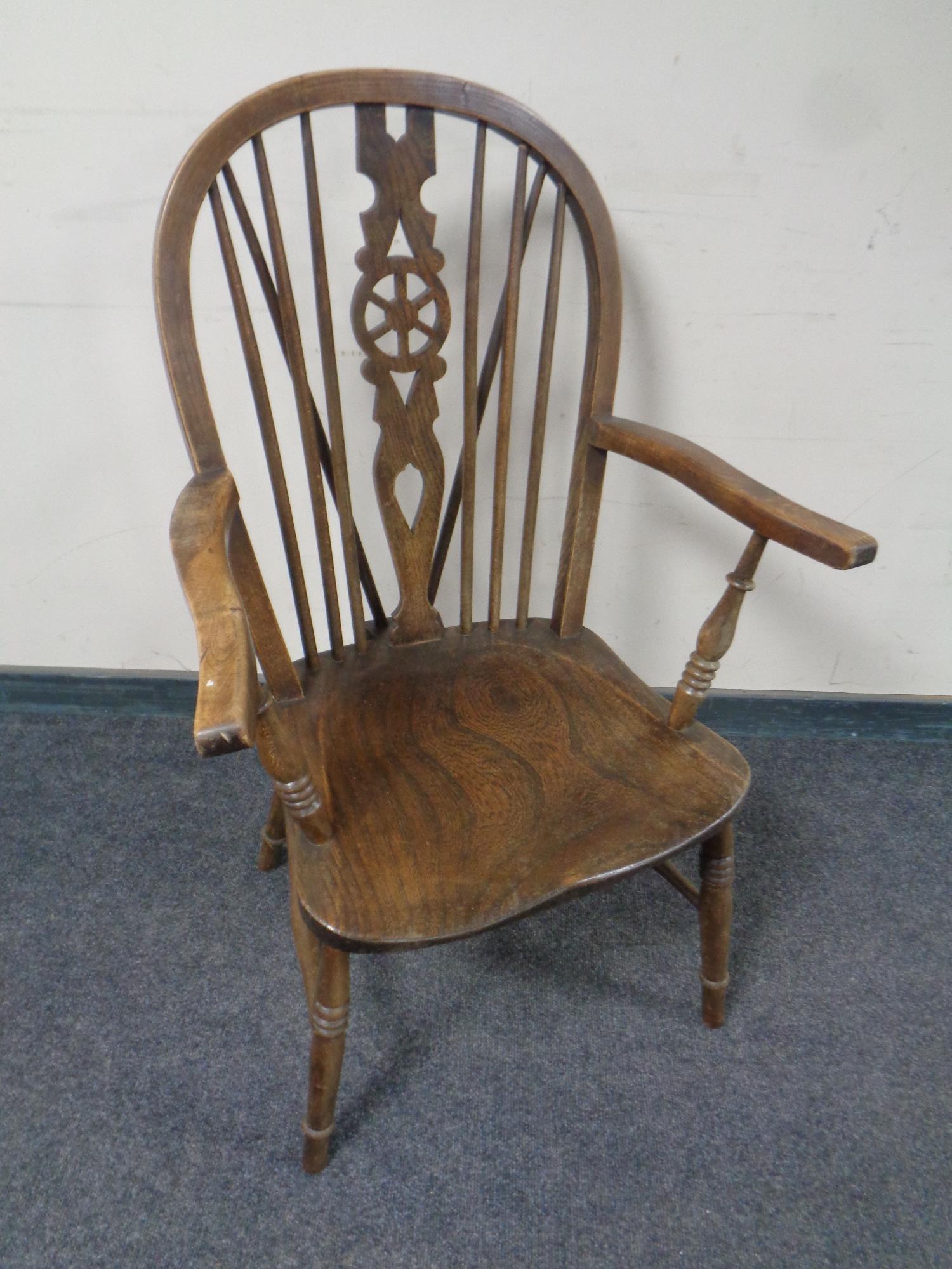 An elm and beech spindle back elbow chair