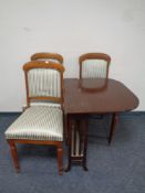 An antique mahogany Sutherland table together with a set of three dining chairs upholstered in a