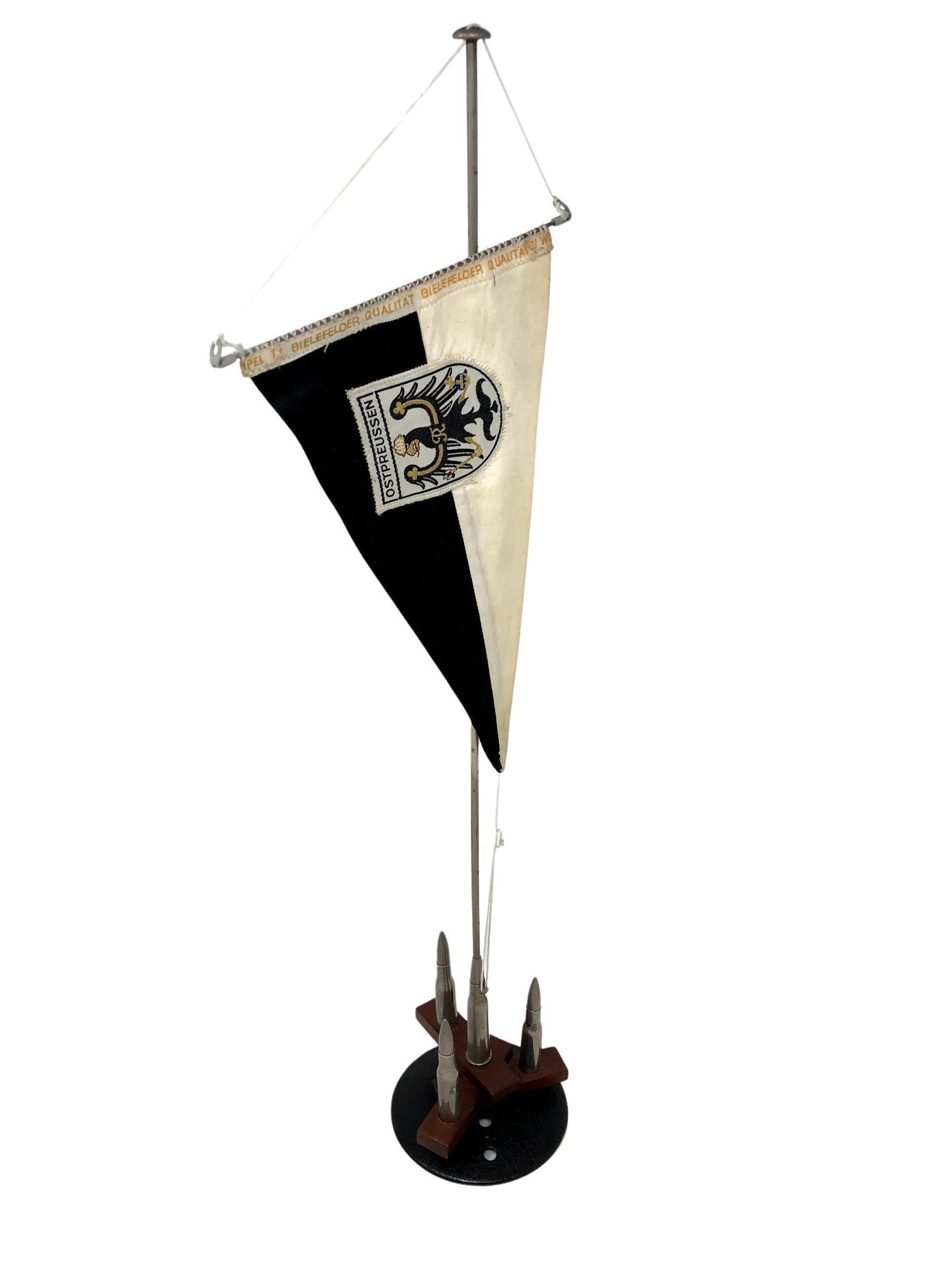 A Post-War pennant and bullet desk ornament.