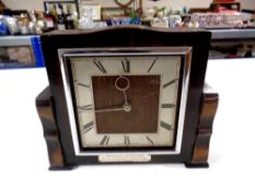 An early 20th century oak mantel clock with silvered dial and presentation plaque presented to Lt.