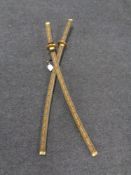 A pair of decorative katana style swords in scabbards