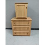 An oak effect three drawer chest together with a matching single door cupboard