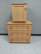 An oak effect three drawer chest together with a matching single door cupboard