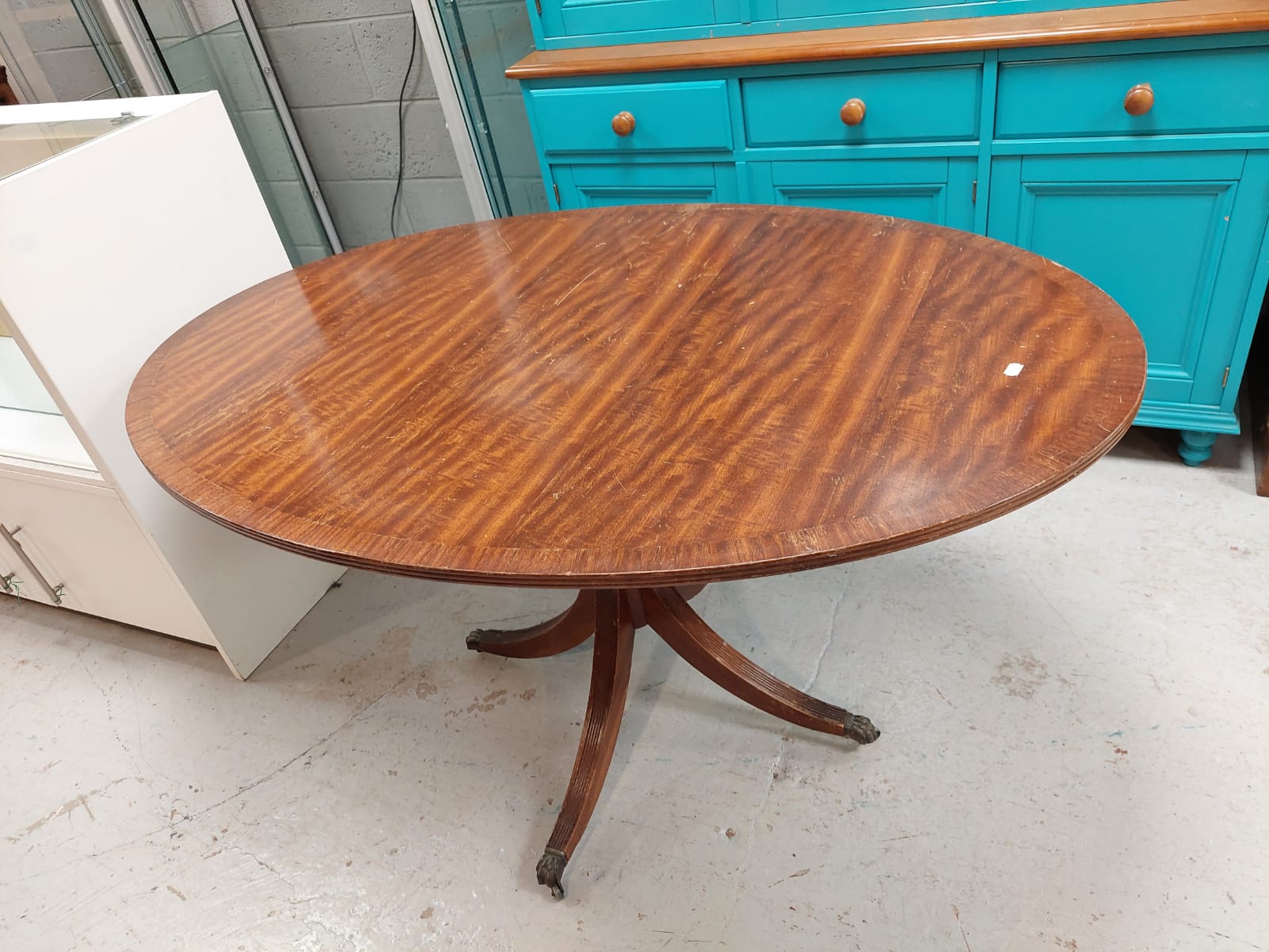 A reproduction mahogany oval dining table