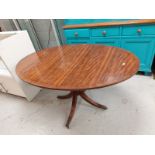 A reproduction mahogany oval dining table