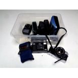 A box containing Olympus OM30 camera, Olympus Trip 35 camera, other cameras including Canon,