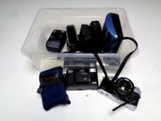 A box containing Olympus OM30 camera, Olympus Trip 35 camera, other cameras including Canon,