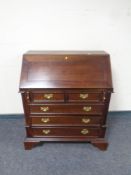 A reproduction fall front writing bureau