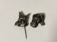 Two silver dog pins