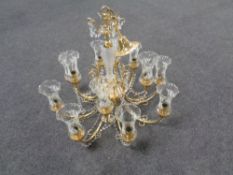 A decorative brass twelve branch chandelier with glass tulip shades and drops