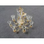 A decorative brass twelve branch chandelier with glass tulip shades and drops