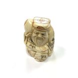 A Chinese bone netsuke - A Village Elder Carrying Fruit.