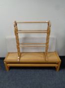 A contemporary oak bench with cushion and under shelf together with a towel rail