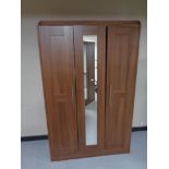 A contemporary wood effect wardrobe with central mirrored door
