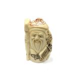 A Chinese bone netsuke - A Beaded Man Holding a Stick.