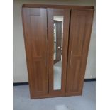 A contemporary wood effect wardrobe with central mirrored door