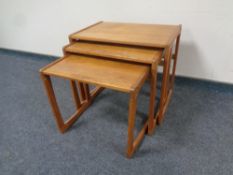 A nest of three mid 20th century teak tables