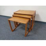 A nest of three mid 20th century teak tables