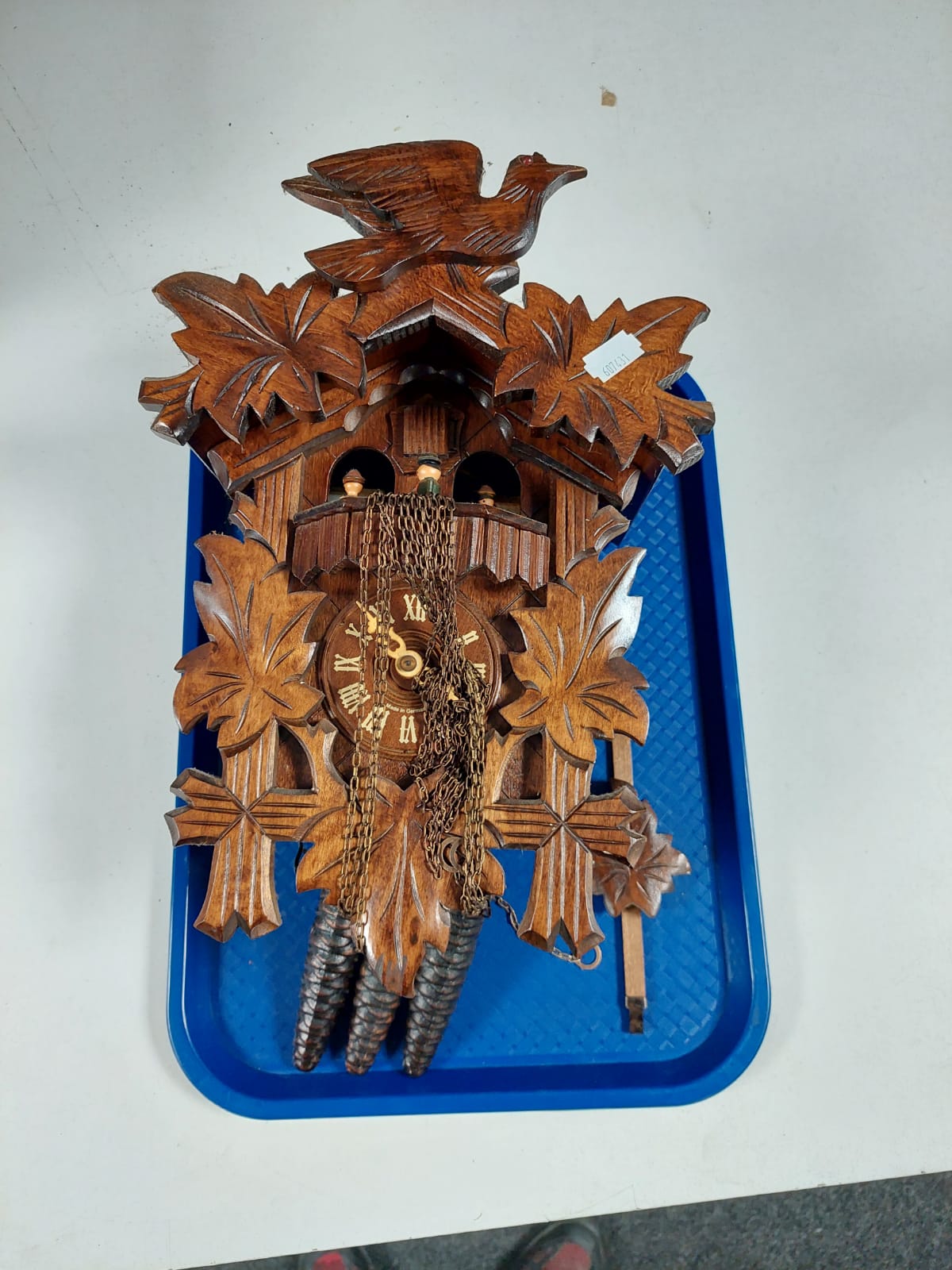 A carved beech wood German cuckoo clock with three weights