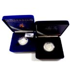 Two Royal Mint silver proof five pound coins, Queen Mother's Centenary Year and The Millennium coin,