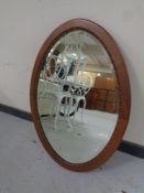 A carved walnut framed oval mirror